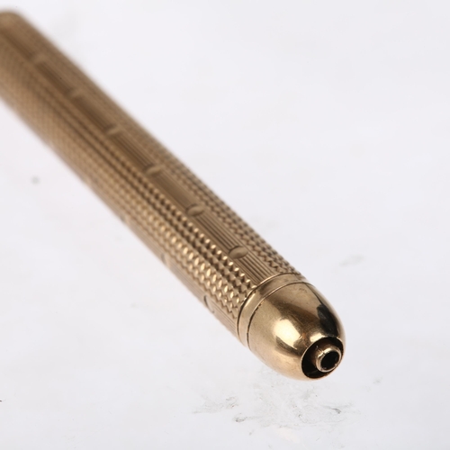 1181 - SAMPSON MORDAN & CO - an early 20th century 9ct gold propelling pencil, circa 1902, allover engine t... 