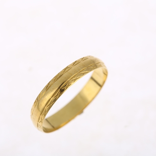 1187 - A late 20th century 18ct gold wedding band ring, maker MS&S, London 1982, engraved cross decoration,... 