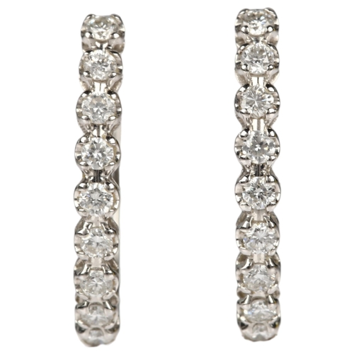 1197 - A pair of 18ct white gold diamond hoop earrings, claw set with modern round brilliant-cut diamonds a... 