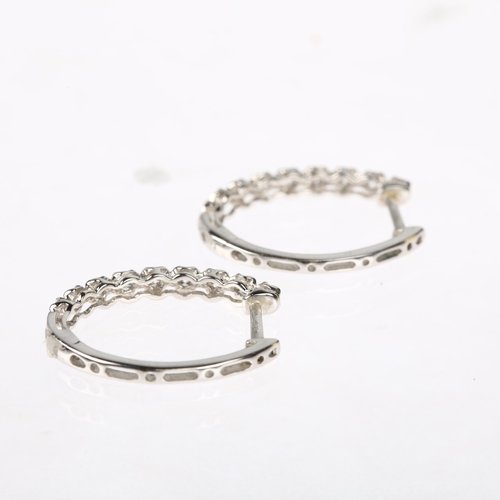 1197 - A pair of 18ct white gold diamond hoop earrings, claw set with modern round brilliant-cut diamonds a... 