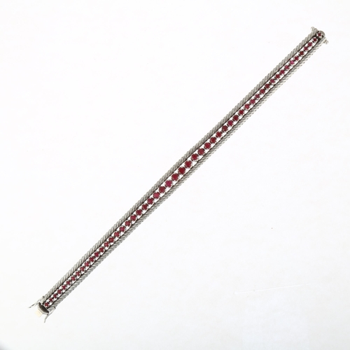 1200 - A mid-20th century 18ct white gold graduated ruby line bracelet, import London 1966, claw set with r... 