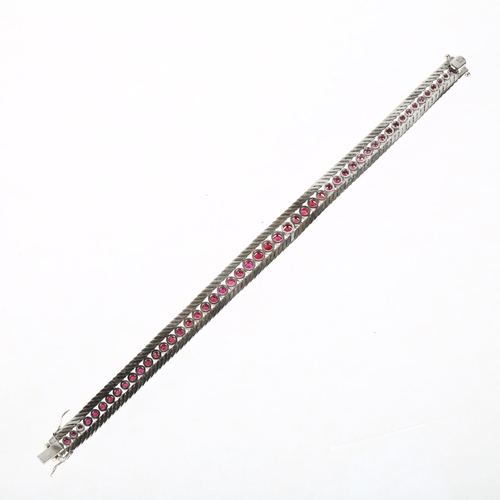 1200 - A mid-20th century 18ct white gold graduated ruby line bracelet, import London 1966, claw set with r... 