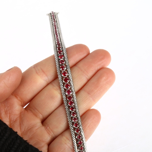 1200 - A mid-20th century 18ct white gold graduated ruby line bracelet, import London 1966, claw set with r... 