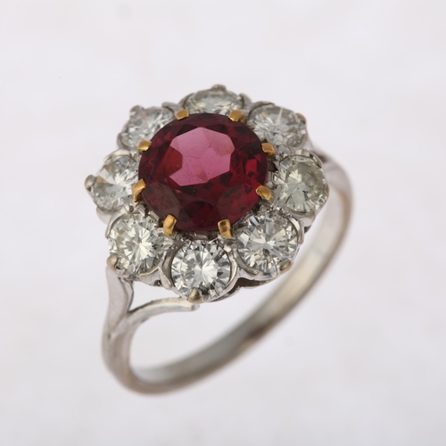 1201 - A fine pyrope garnet and diamond flowerhead cluster ring, claw set with 2ct round-cut garnet surroun... 