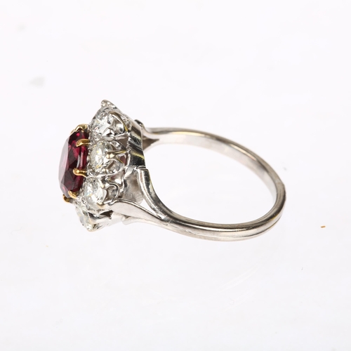 1201 - A fine pyrope garnet and diamond flowerhead cluster ring, claw set with 2ct round-cut garnet surroun... 