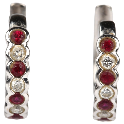 1202 - A pair of 18ct white gold ruby and diamond hoop earrings, set with round-cut rubies and diamonds wit... 