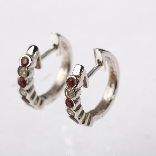 1202 - A pair of 18ct white gold ruby and diamond hoop earrings, set with round-cut rubies and diamonds wit... 