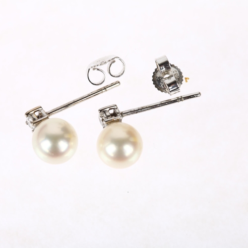 1207 - A pair of 18ct white gold whole pearl and diamond earrings, each claw set with 0.07ct modern round b... 