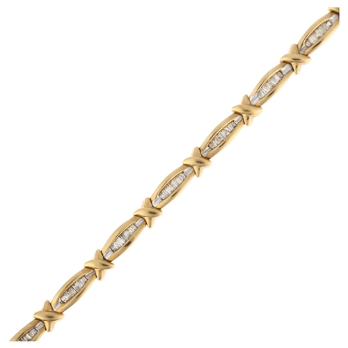 1209 - A 9ct gold diamond line bracelet, set with tapered baguette-cut diamonds, total diamond content appr... 