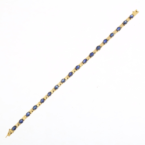 1212A - An 18ct gold sapphire tennis line bracelet, claw set with oval mixed-cut sapphires, 16.5cm, 10.3g