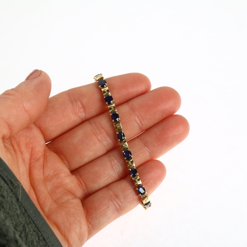 1212A - An 18ct gold sapphire tennis line bracelet, claw set with oval mixed-cut sapphires, 16.5cm, 10.3g