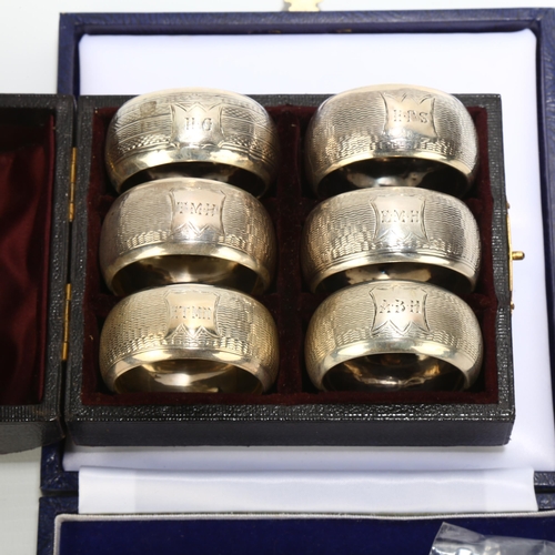 1693 - A cased set of 6 Victorian silver napkin rings, Nathan & Hayes, Birmingham 1893, 4.5cm, 2.4oz, and a... 