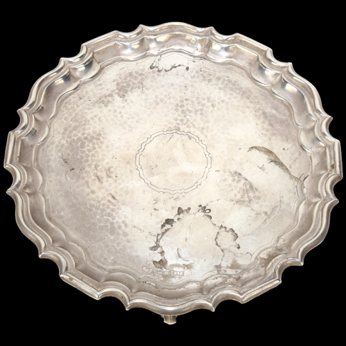 1709 - A George V circular silver salver, Walker & Hall, Sheffield 1934, scalloped rim with planished decor... 