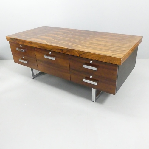 A contemporary rosewood veneered low sideboard in the manner of Gordon Russell, with four drawers and raised on a brushed metal frame. 158x61x74cm.