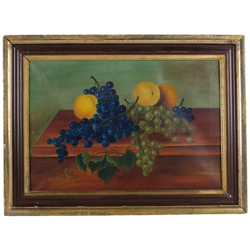 146 - An Antique oil on canvas still life painting, grapes and citrus fruits on a table, unsigned, in a wo... 