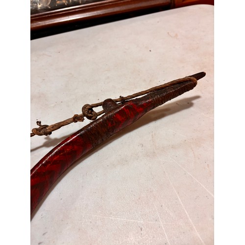 94 - A traditional Mongolian bow,  wood construction with painted chevron detail and leather strapping, l... 