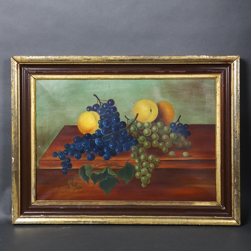 146 - An Antique oil on canvas still life painting, grapes and citrus fruits on a table, unsigned, in a wo... 