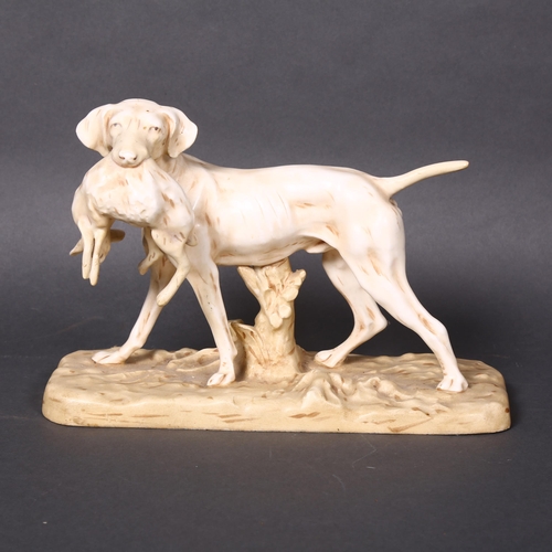 164 - A Royal Dux porcelain sculpture of a hunting dog with a hare in its mouth on a naturalistic base, he... 