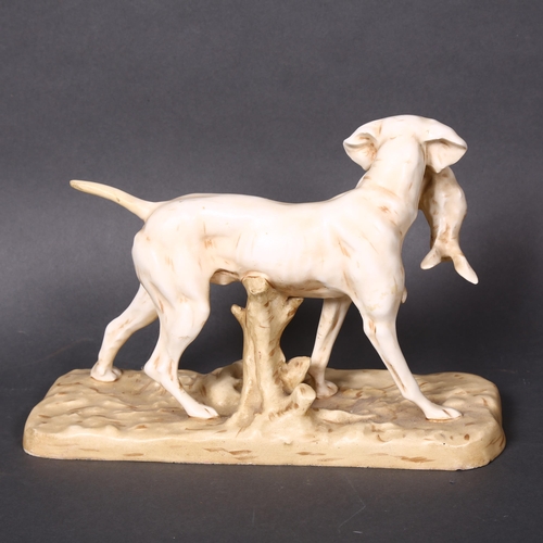 164 - A Royal Dux porcelain sculpture of a hunting dog with a hare in its mouth on a naturalistic base, he... 