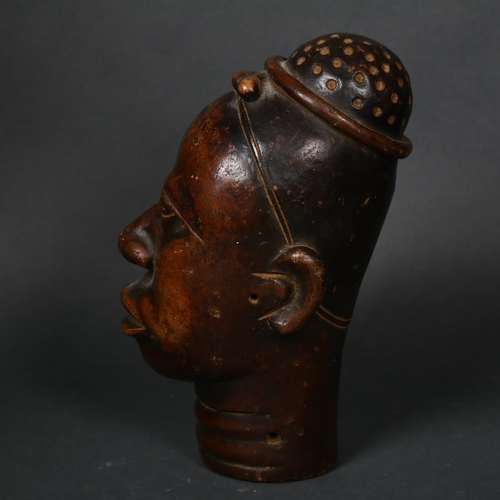 173 - An early 20th century Nigerian terracotta head, height 22cm.