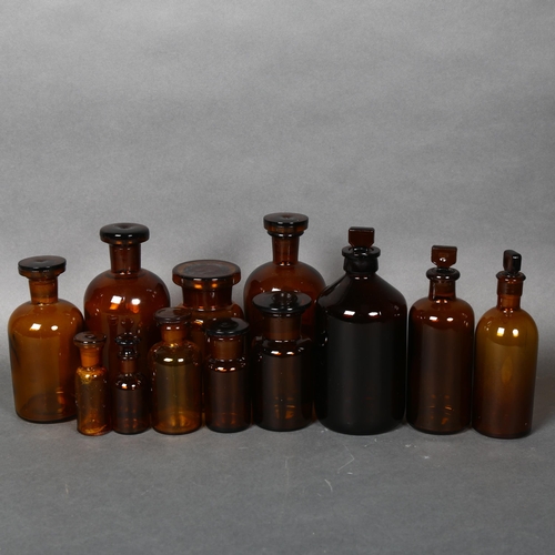 174 - A collection of Mid-century Amber apothecary bottles, various sizes, all including stoppers, largest... 