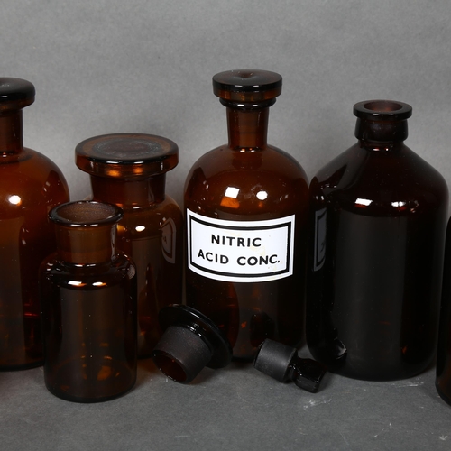 174 - A collection of Mid-century Amber apothecary bottles, various sizes, all including stoppers, largest... 