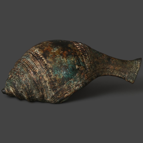 343 - A 12th or 13th century Khymer bronze libation vessel in the former of a conch shell, length 24cm.