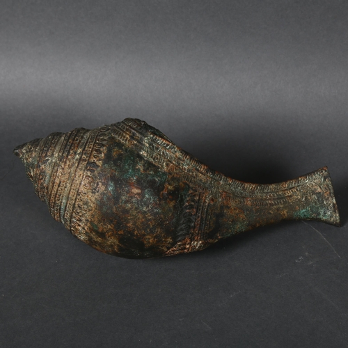 343 - A 12th or 13th century Khymer bronze libation vessel in the former of a conch shell, length 24cm.