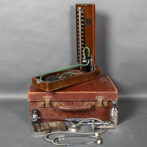 435 - A vintage Doctors medical bag, containing various vintage medical instruments including a stethoscop... 