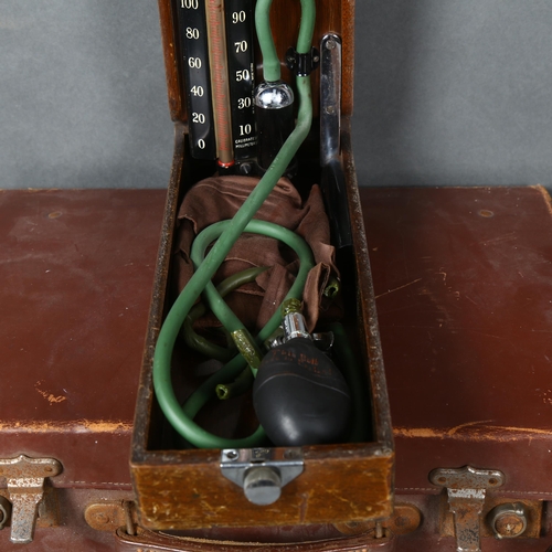 435 - A vintage Doctors medical bag, containing various vintage medical instruments including a stethoscop... 