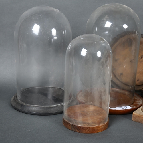 451 - A group of various vintage an other glass domes, some with associated stands, additional spare woode... 