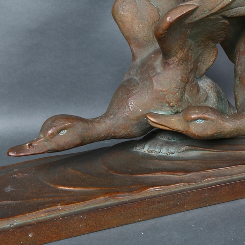 473 - A large patinated bronzed terracotta study of flying geese, signed R Pollin, L72cm