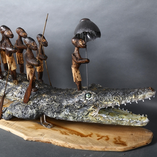 474 - Clive Fredriksson - A mixed media study, figures riding atop a Crocodile, stand, L150cm