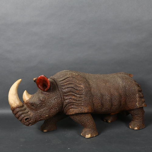 479 - A large carved hardwood study of a Rhinoceros  L67cm