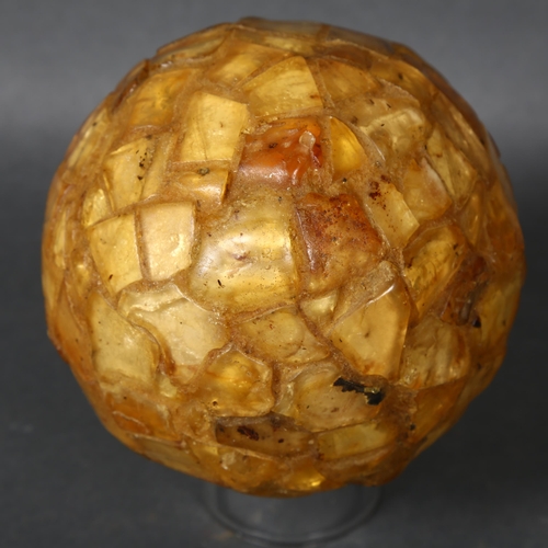 497 - Fossil Curiosity “The Amber Egg”, Ostrich Egg covered in Genuine Copal, an interesting addition to a... 