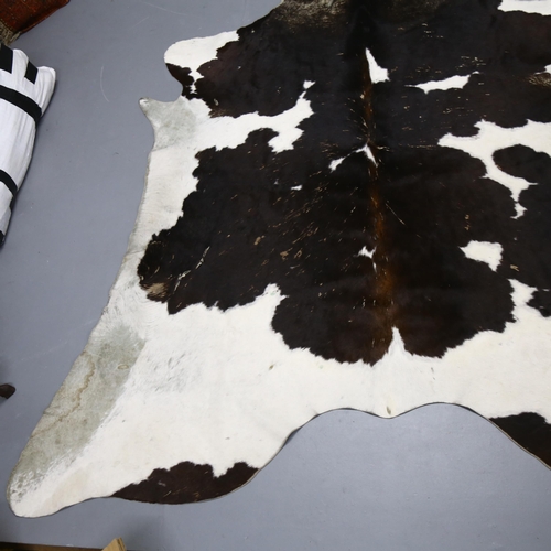 367 - Taxidermy - a Large Black and White Cow Skin Hide Rug, approximately 190cm x 150cm.