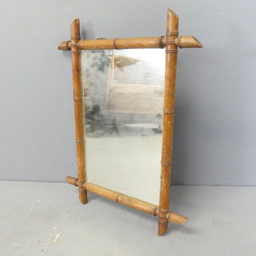 2700 - An early 20th century faux bamboo framed wall mirror. 60x47cm.