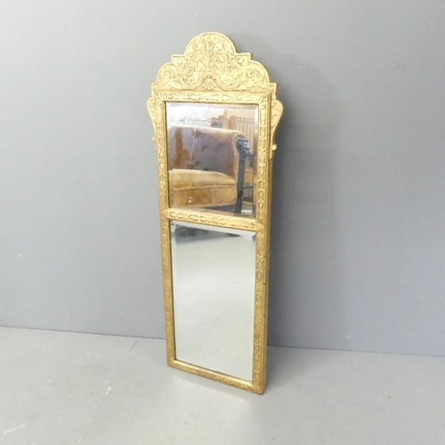 2705 - A continental gilt framed wall mirror with bevel edged glass and carved decoration. 42x107cm.