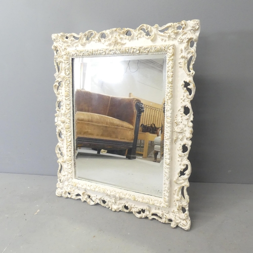 2707 - A French rectangular bevel edged wall mirror with carved and pierced decorations. 59x70cm