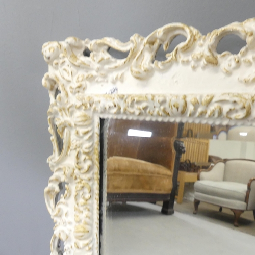 2707 - A French rectangular bevel edged wall mirror with carved and pierced decorations. 59x70cm