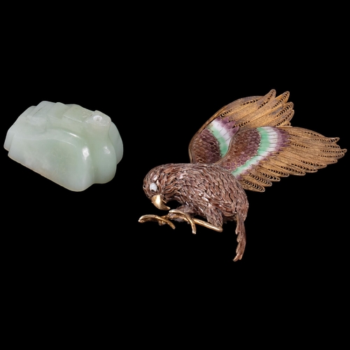 385 - A decorative patinated humming bird with silver gilt and coloured enamel wings, mounted on a green j... 