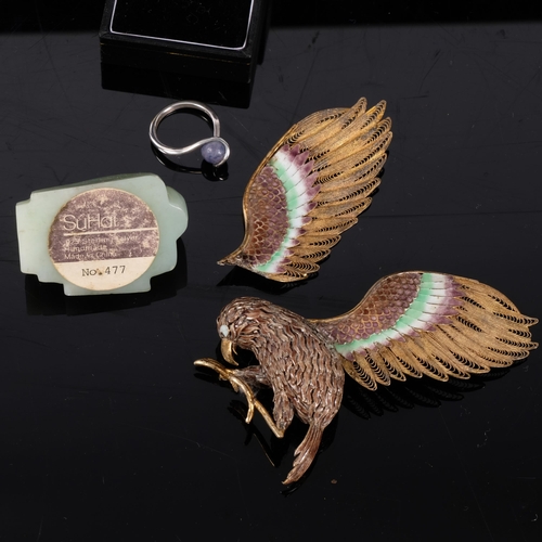 385 - A decorative patinated humming bird with silver gilt and coloured enamel wings, mounted on a green j... 