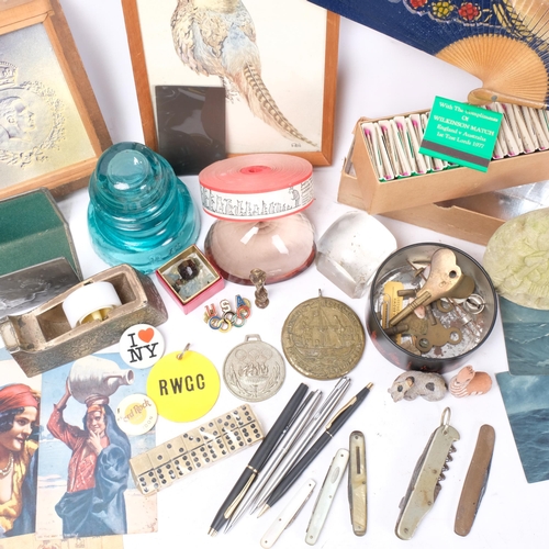 402 - A group of various items, to include BBC matchbooks, badges, large cotton reel desk weights etc