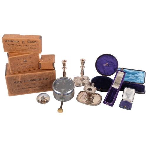 687 - A pair of candlesticks, 11cm, chamber stick, Smiths clock, and empty boxes