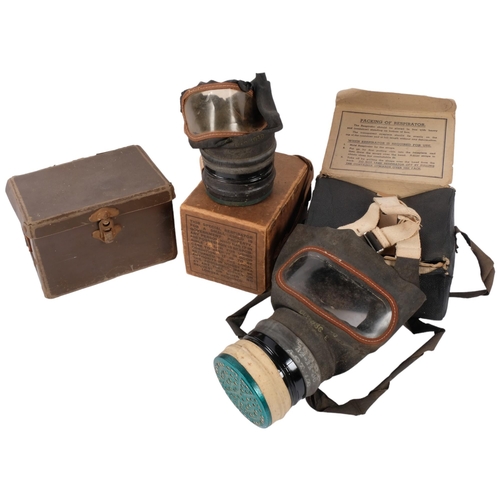 688 - 2 cased gas masks, and an empty box