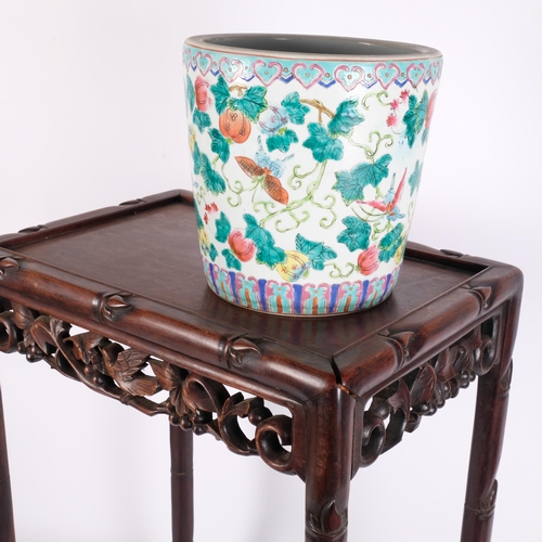 118 - A Chinese hardwood side table with a floral and bird carved frieze (originally part of a nest of tab... 