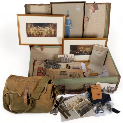 153 - A collection of military postcards, pictures, booklets, buttons, buckle, canvas bag, etc, in a leath... 