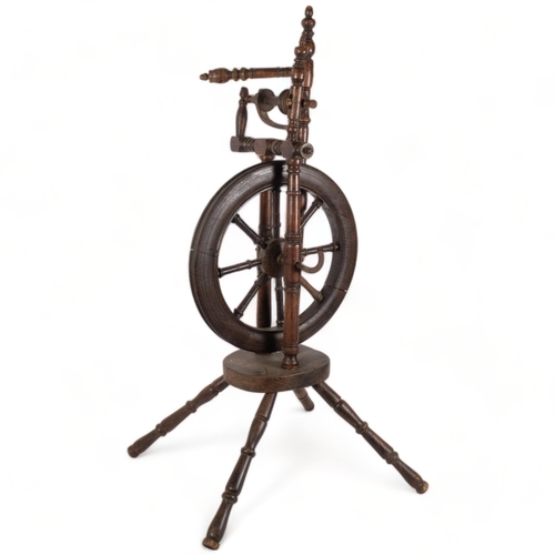 157 - A turned elm spinning wheel, H98cm