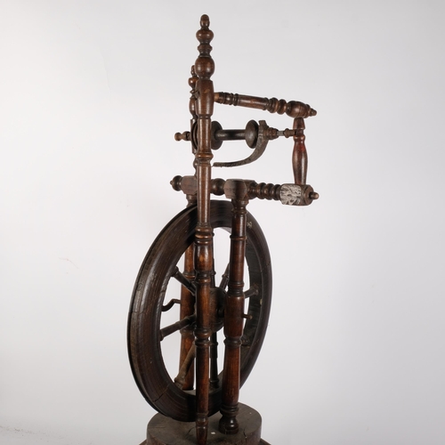 157 - A turned elm spinning wheel, H98cm