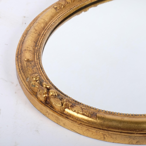 161 - An oval gilt-framed wall mirror, H52cm